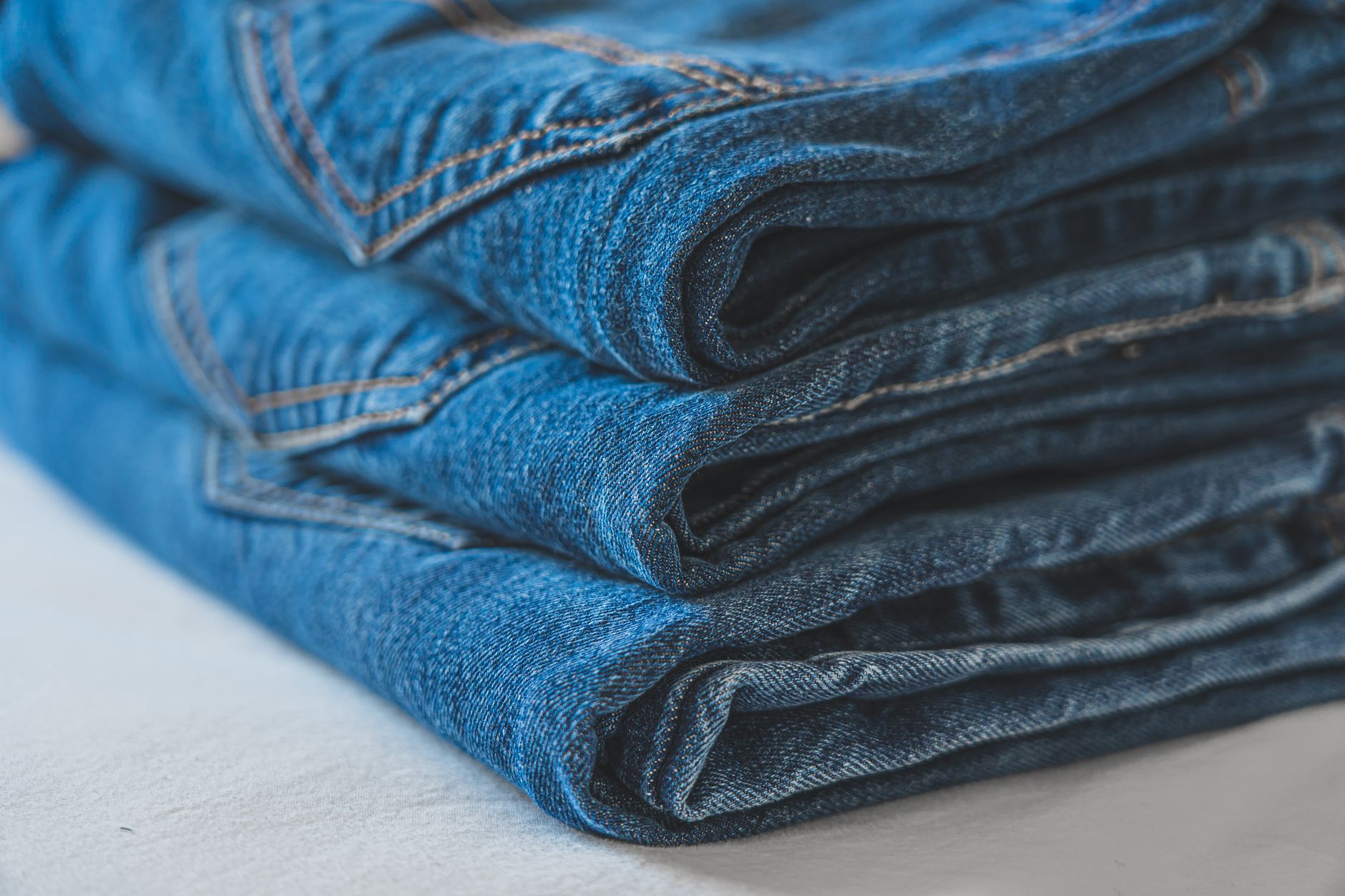 Merino wool travel trousers folded on a hotel bed