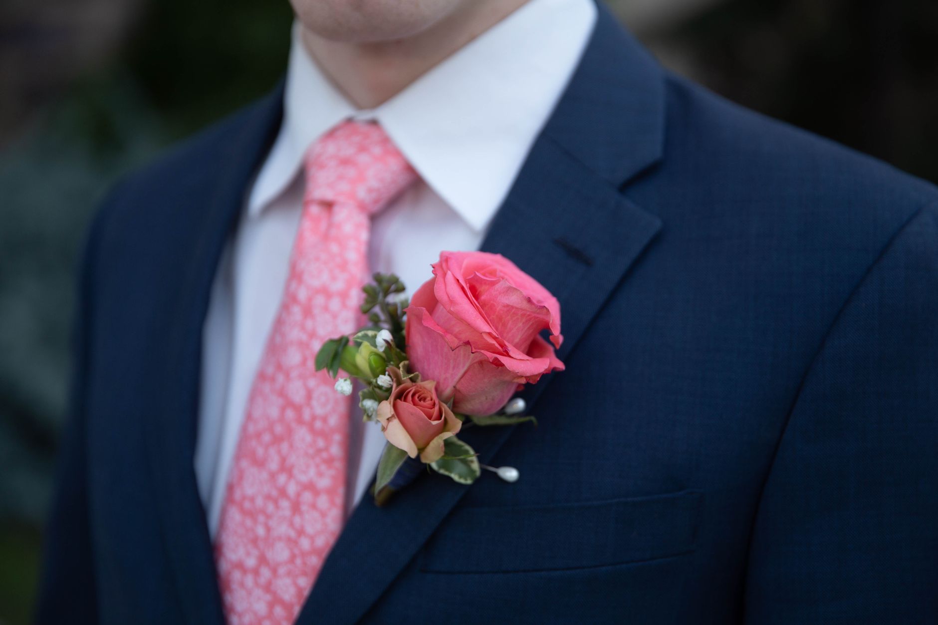 Male wedding guest in a navy formal suit with a tie and polished brown shoes