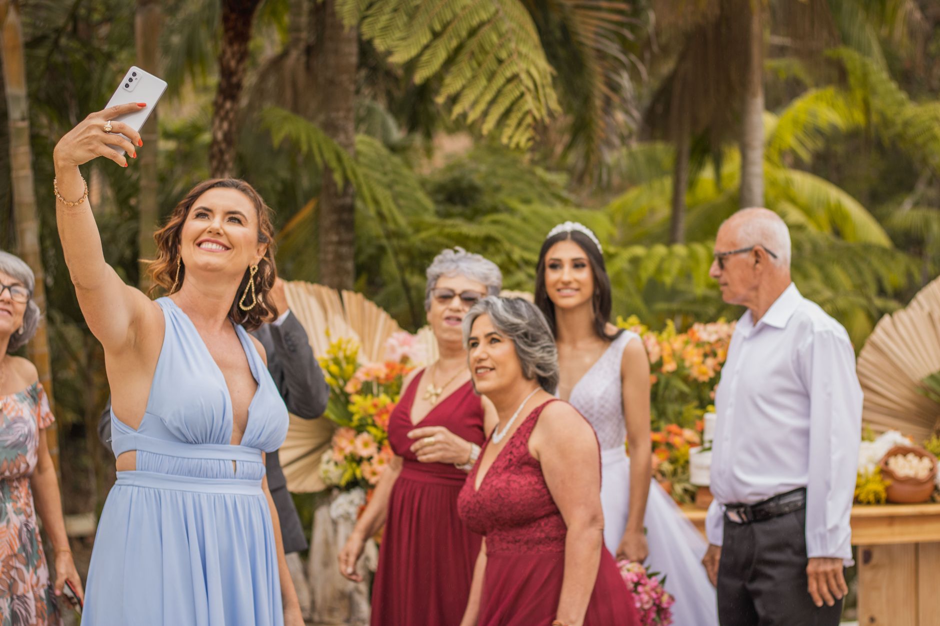 Woman in a knee-length cocktail dress and heels at a wedding reception