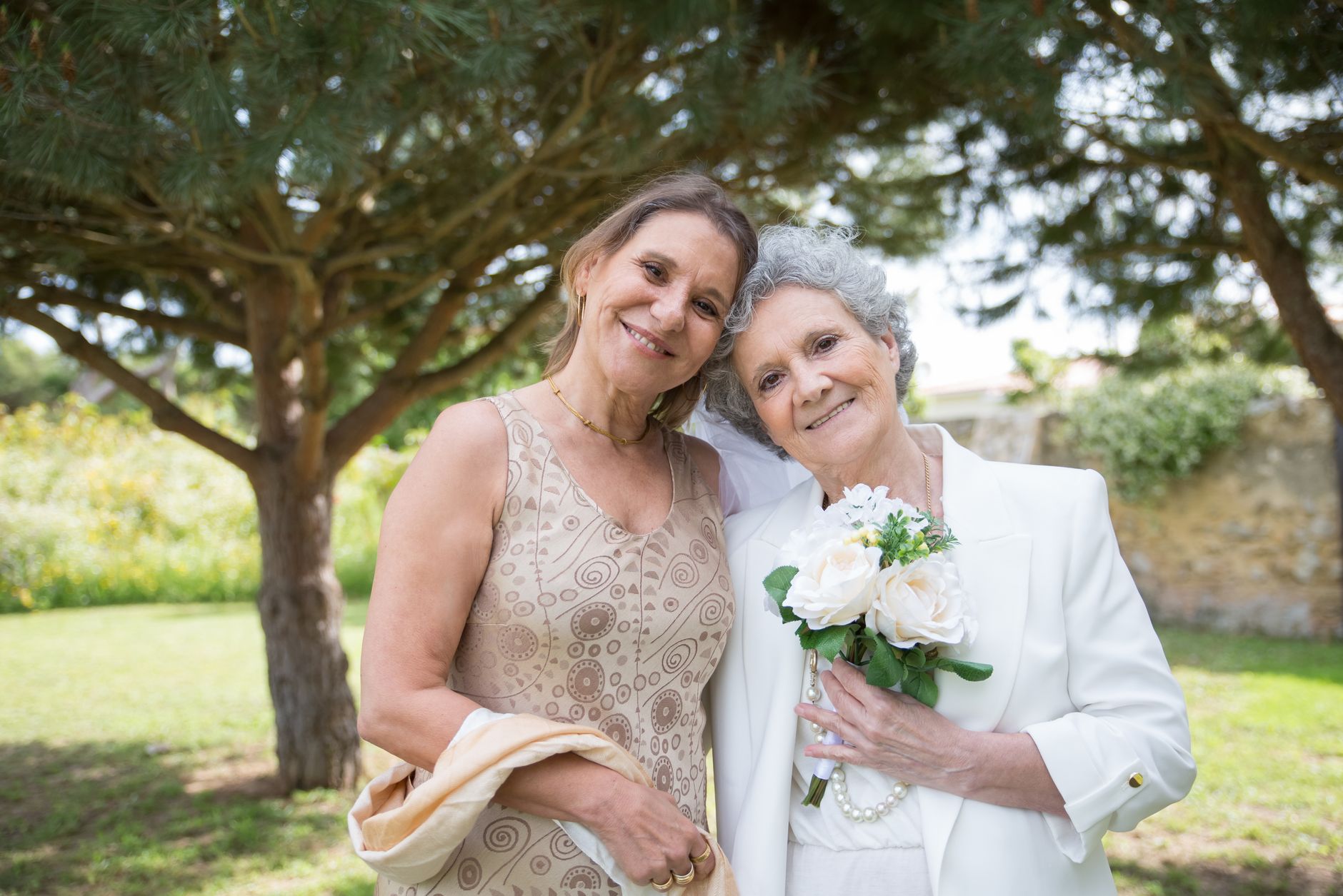 Woman over 50 in an elegant midi dress with three-quarter sleeves at a wedding