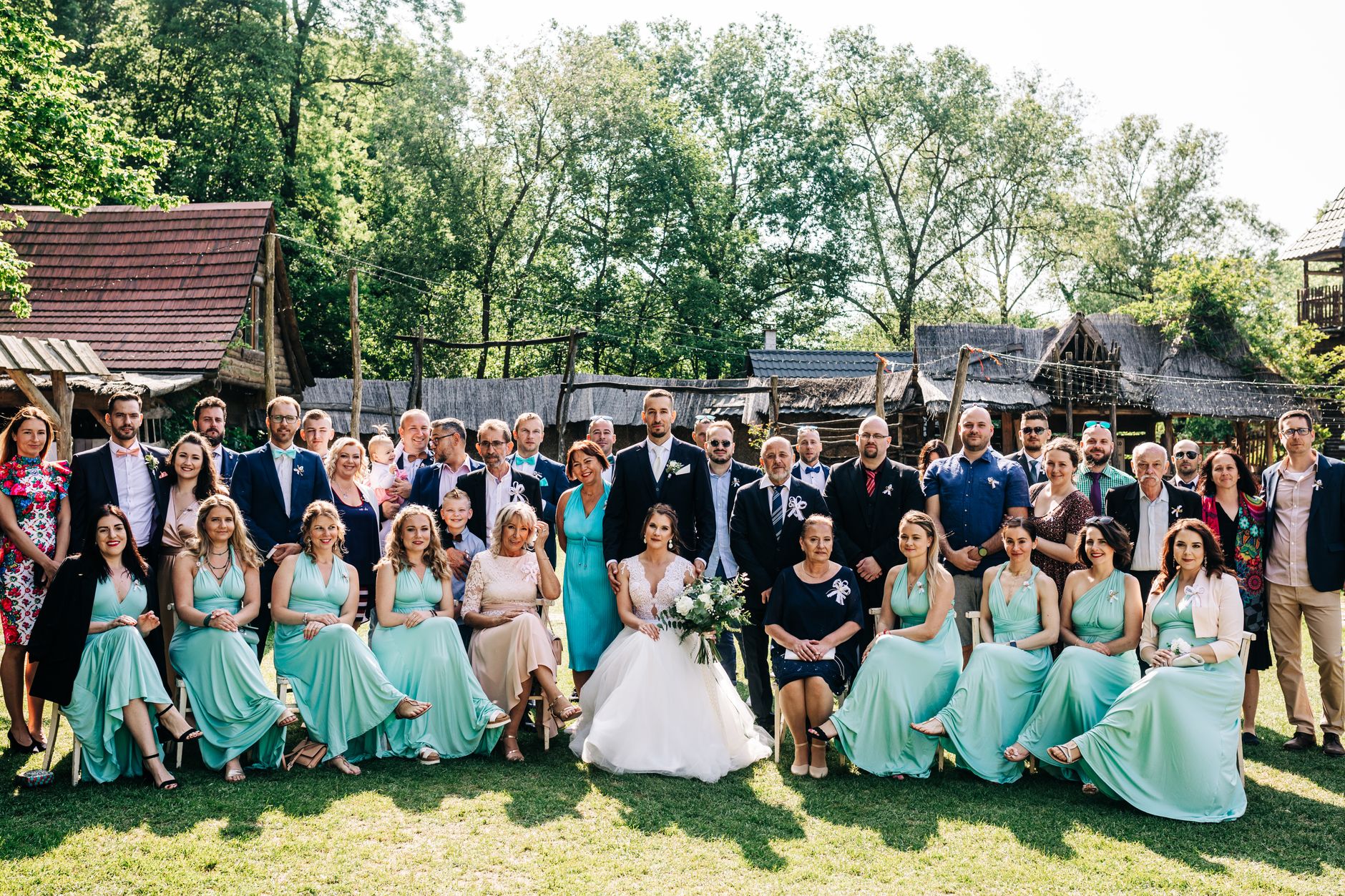 Autumn barn wedding guests in tweed jackets and rust-toned dresses