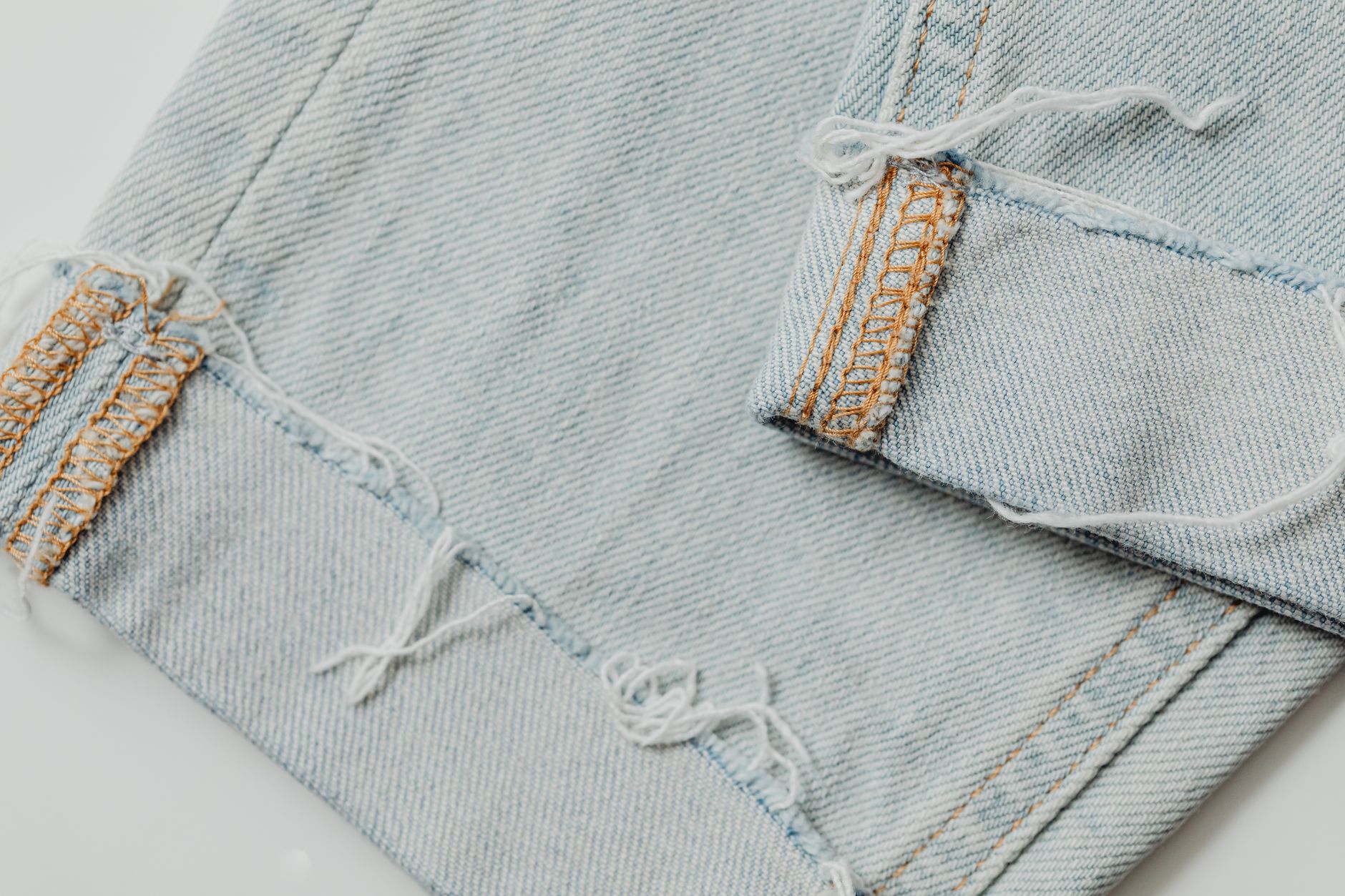 Ripped light-wash jeans that do not meet a business casual dress code