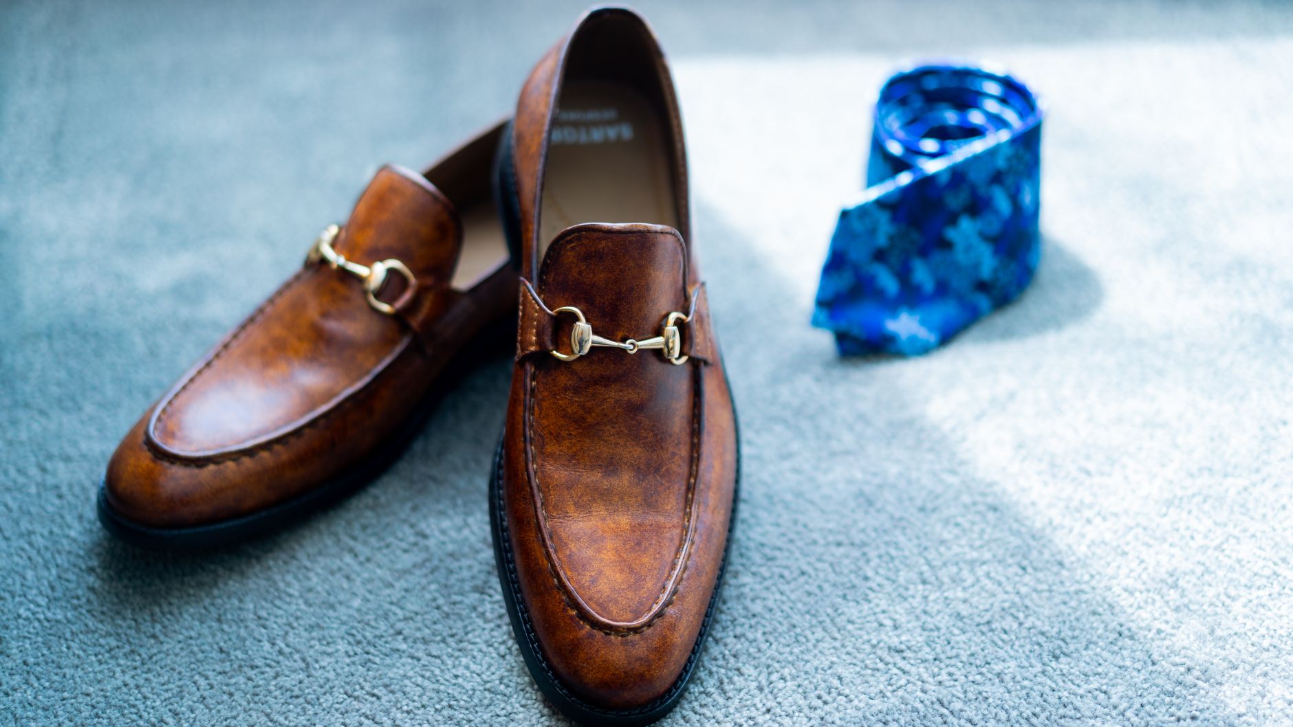 Brown loafers, black derbies and suede chukka boots as business casual shoe options