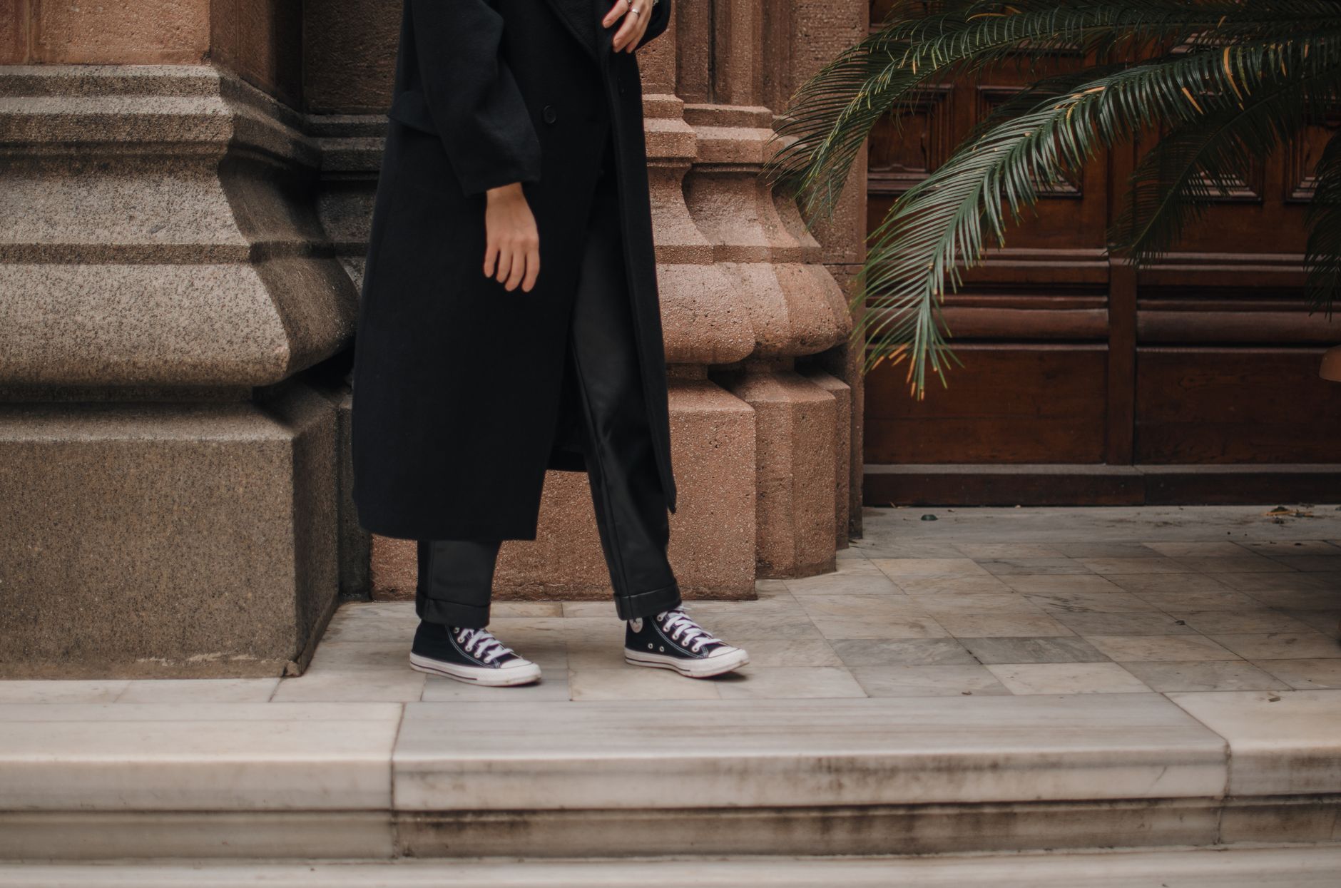 Wide-leg baggy black trousers with a tucked white tee and loafers