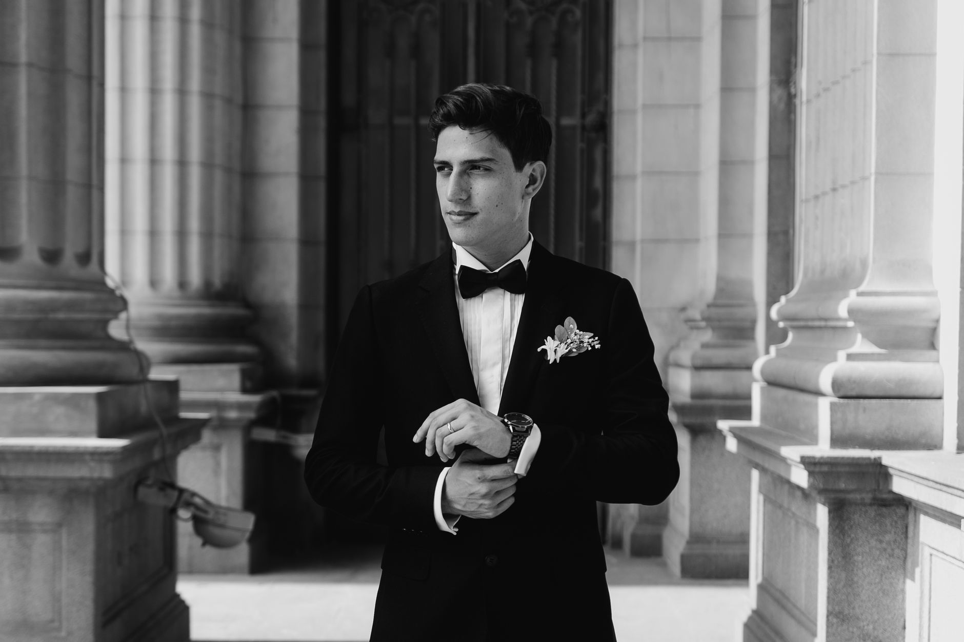 Wedding guest in a classic black tuxedo with bow tie at an evening reception