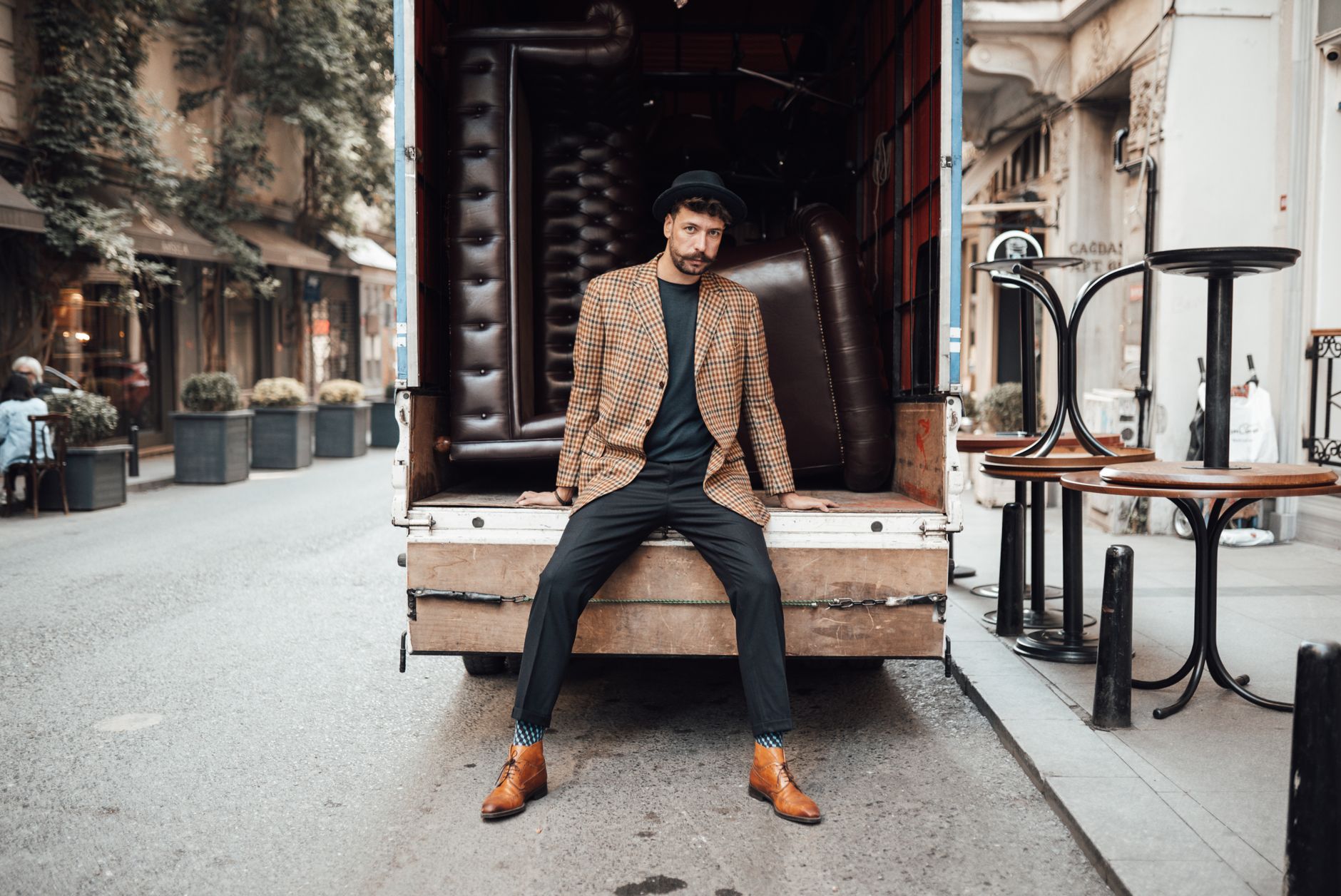 Slim navy suit with narrow lapels, knit tie and Chelsea boots