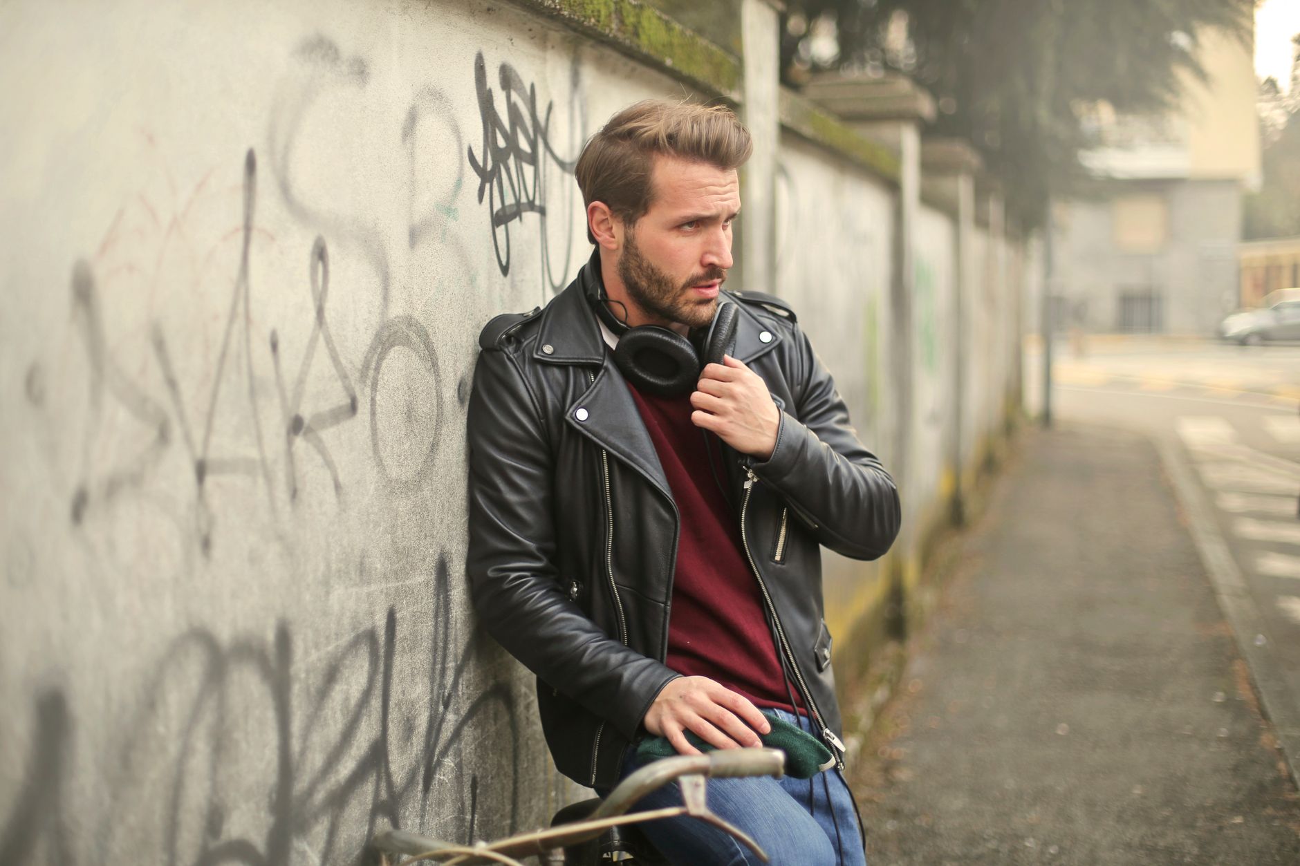 1950s greaser style with white t-shirt, cuffed jeans and black leather jacket