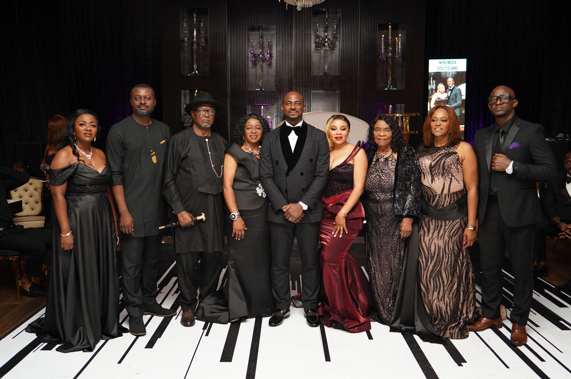 Guests in black tie attire at an evening gala