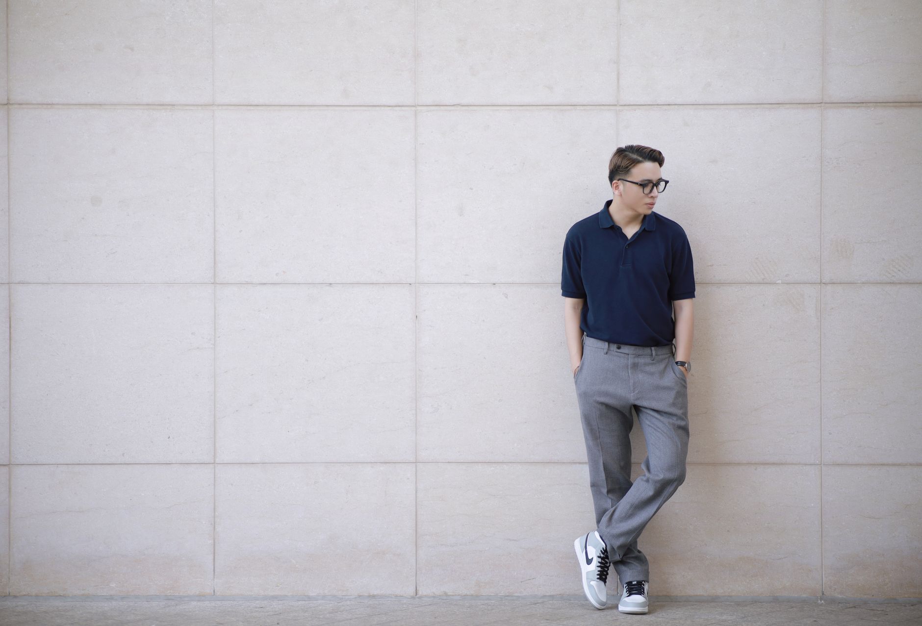 Navy knit polo shirt with olive chinos and white minimal leather sneakers