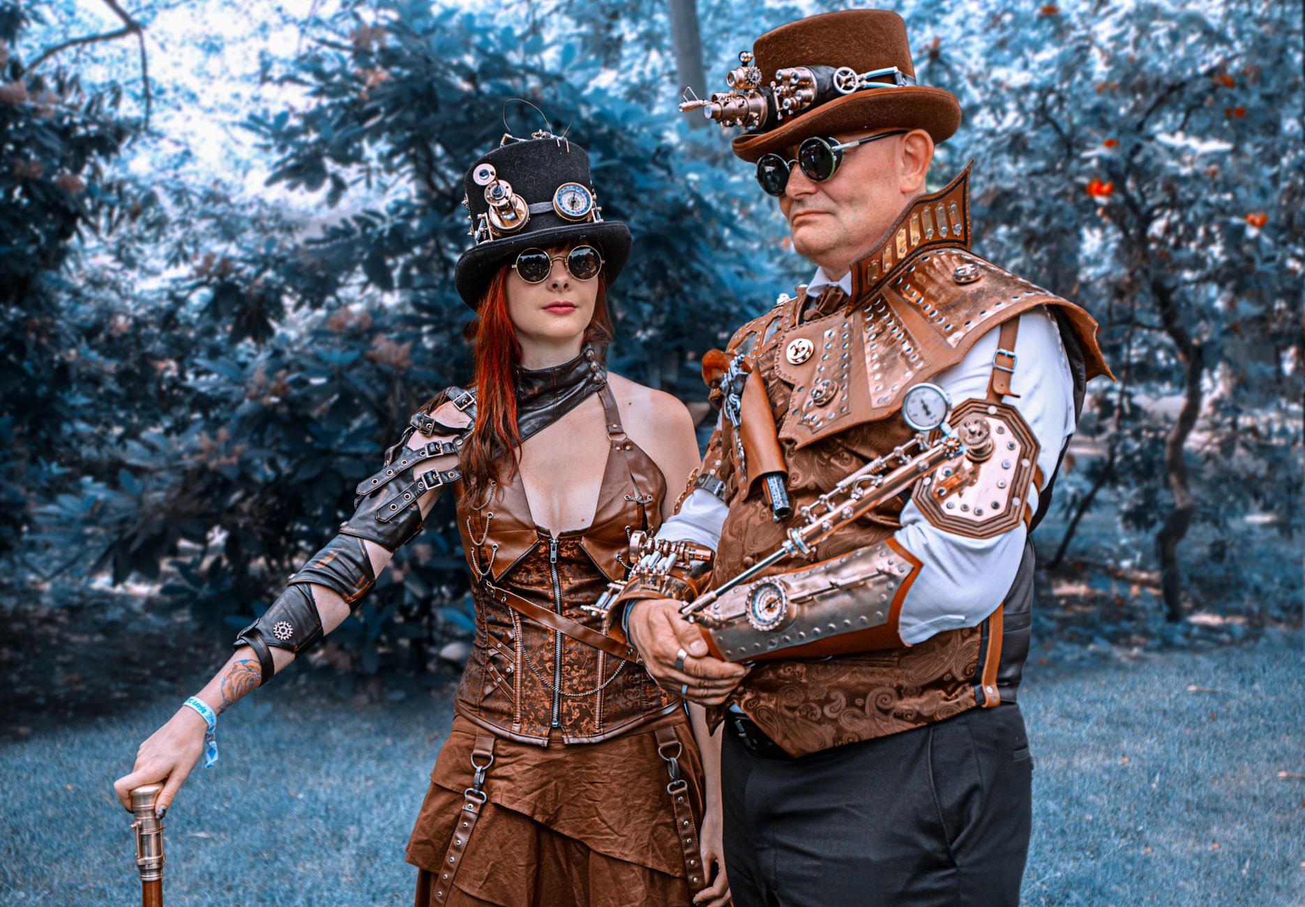 Steampunk couple in coordinated brown and brass costumes