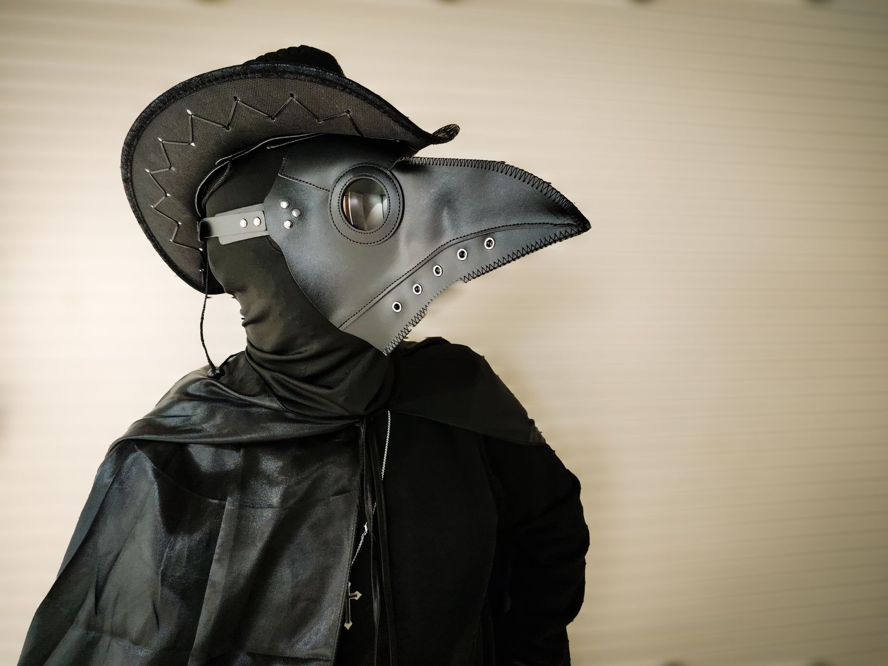 Steampunk plague doctor costume with beaked leather mask and wide-brimmed hat