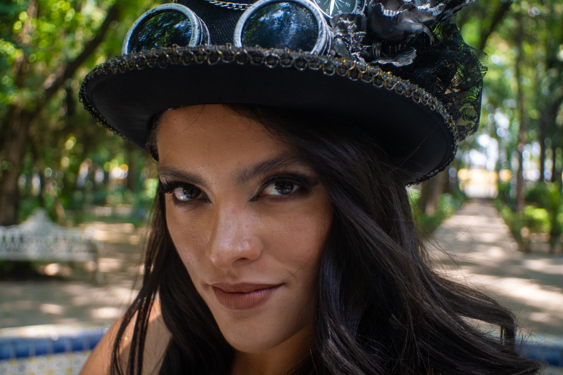Steampunk aviatrix in a leather flight helmet, aviator goggles and cropped jacket