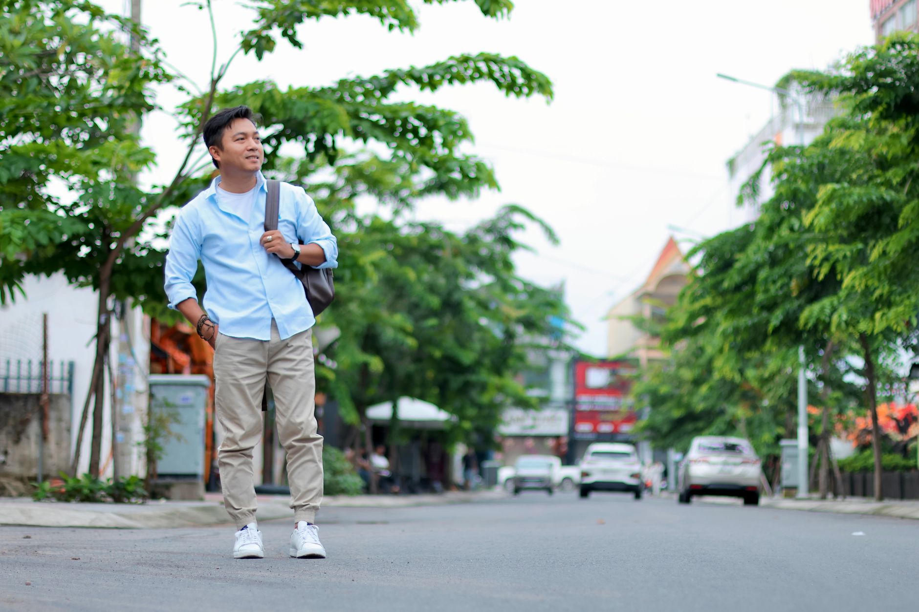 Man wearing a light blue oxford shirt with stone chinos and brown loafers