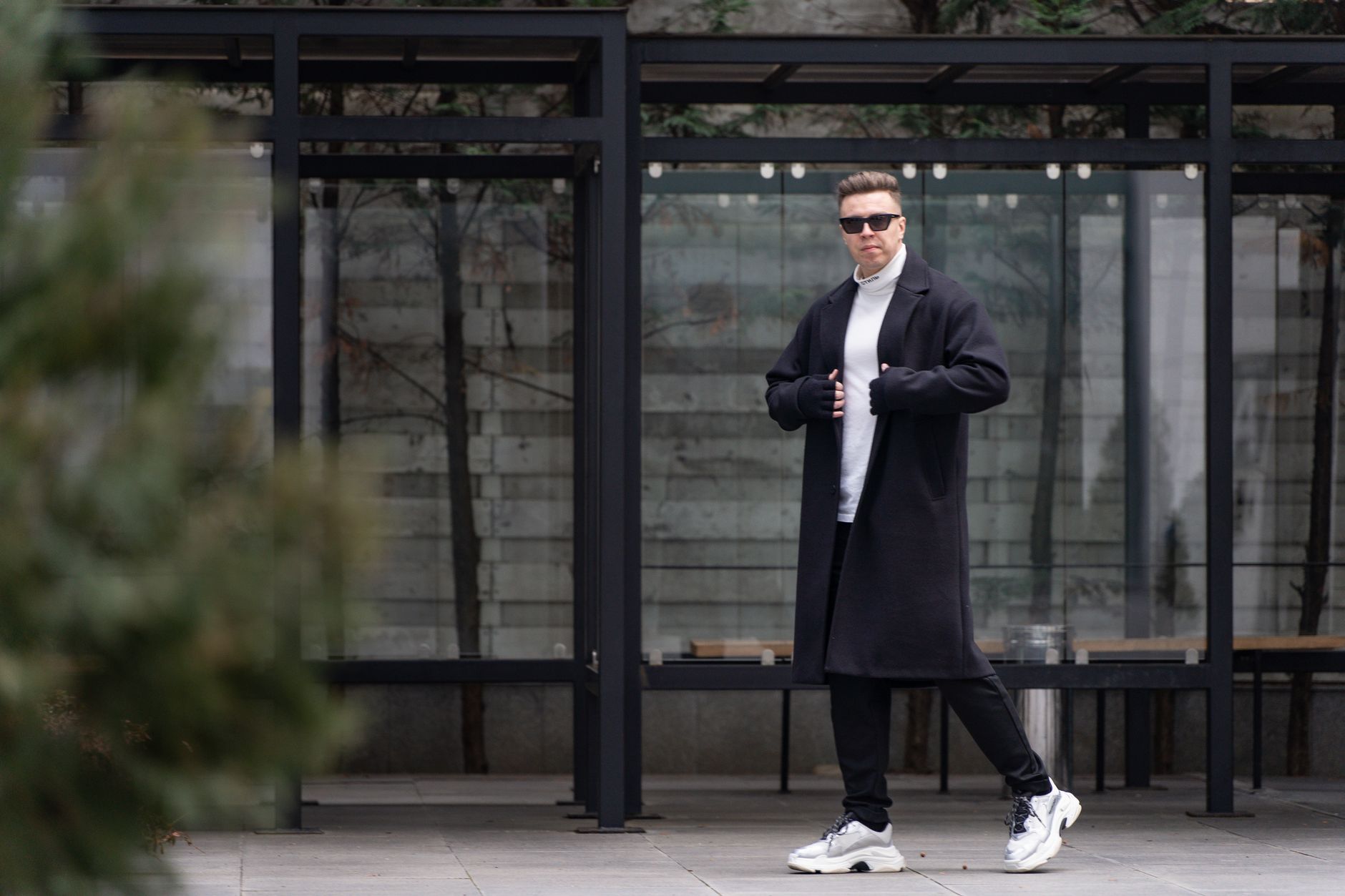 Black fine-gauge turtleneck under a blazer with dark trousers