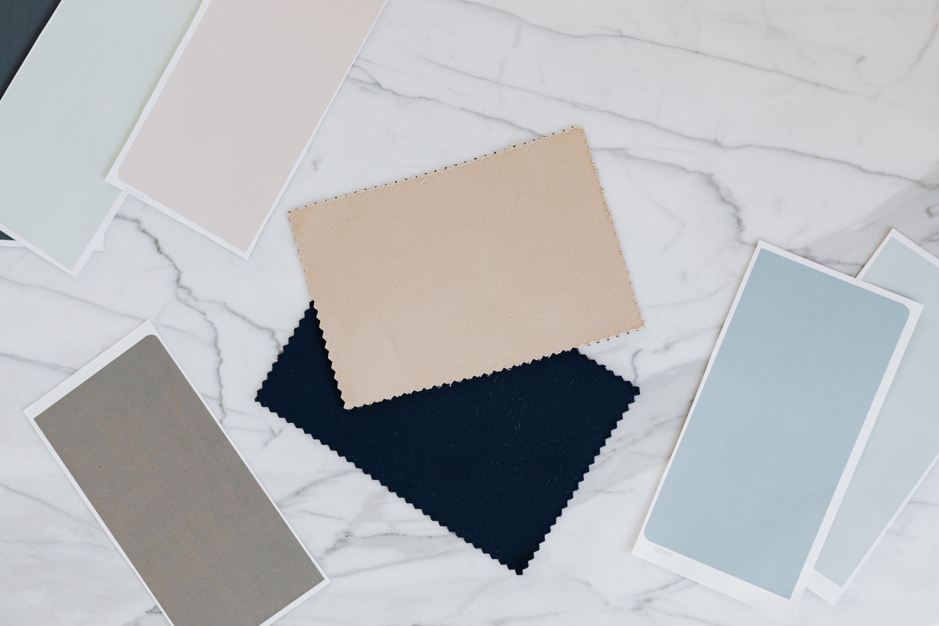 Flat lay of linen, seersucker, tropical wool and cotton fabric swatches