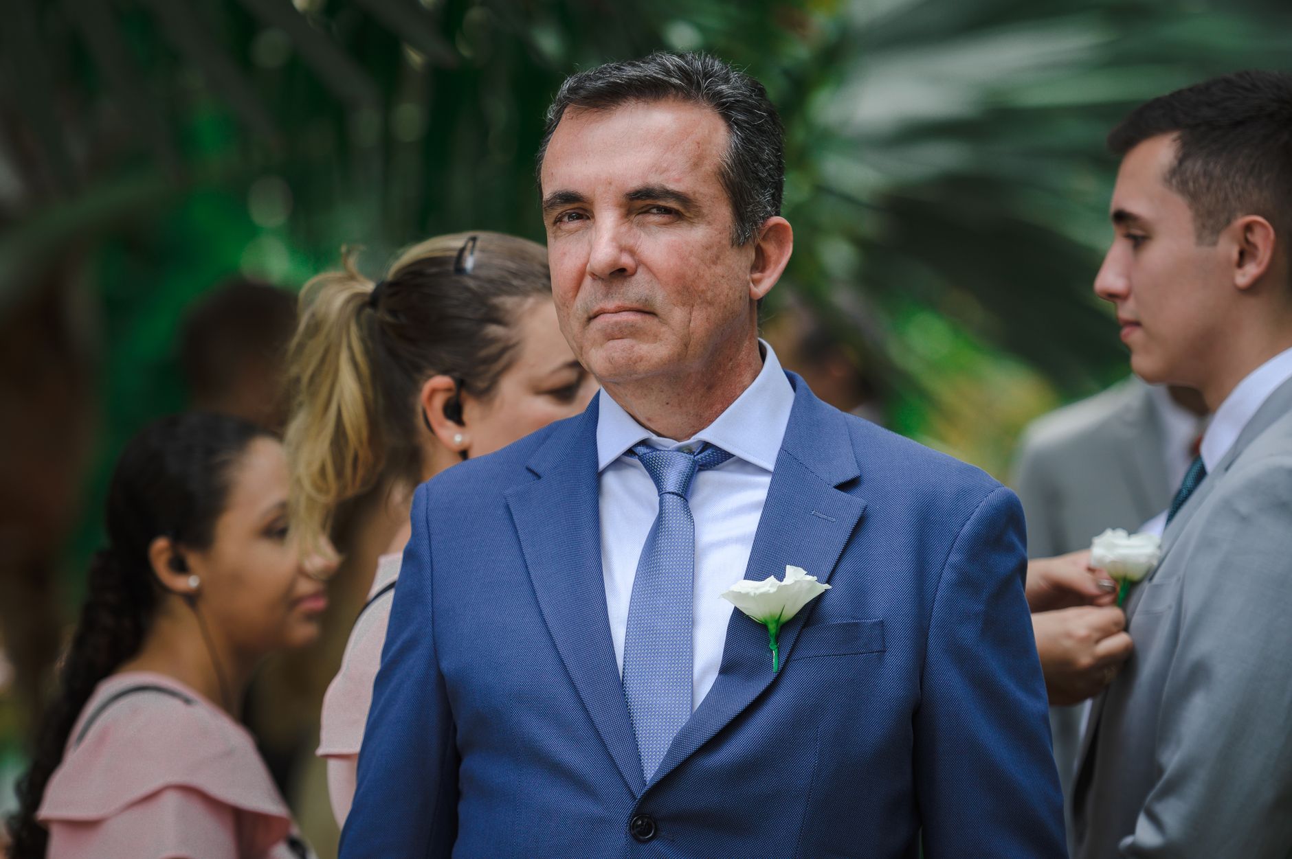 Grey cocktail attire suit with a knitted tie and pocket square for a wedding guest