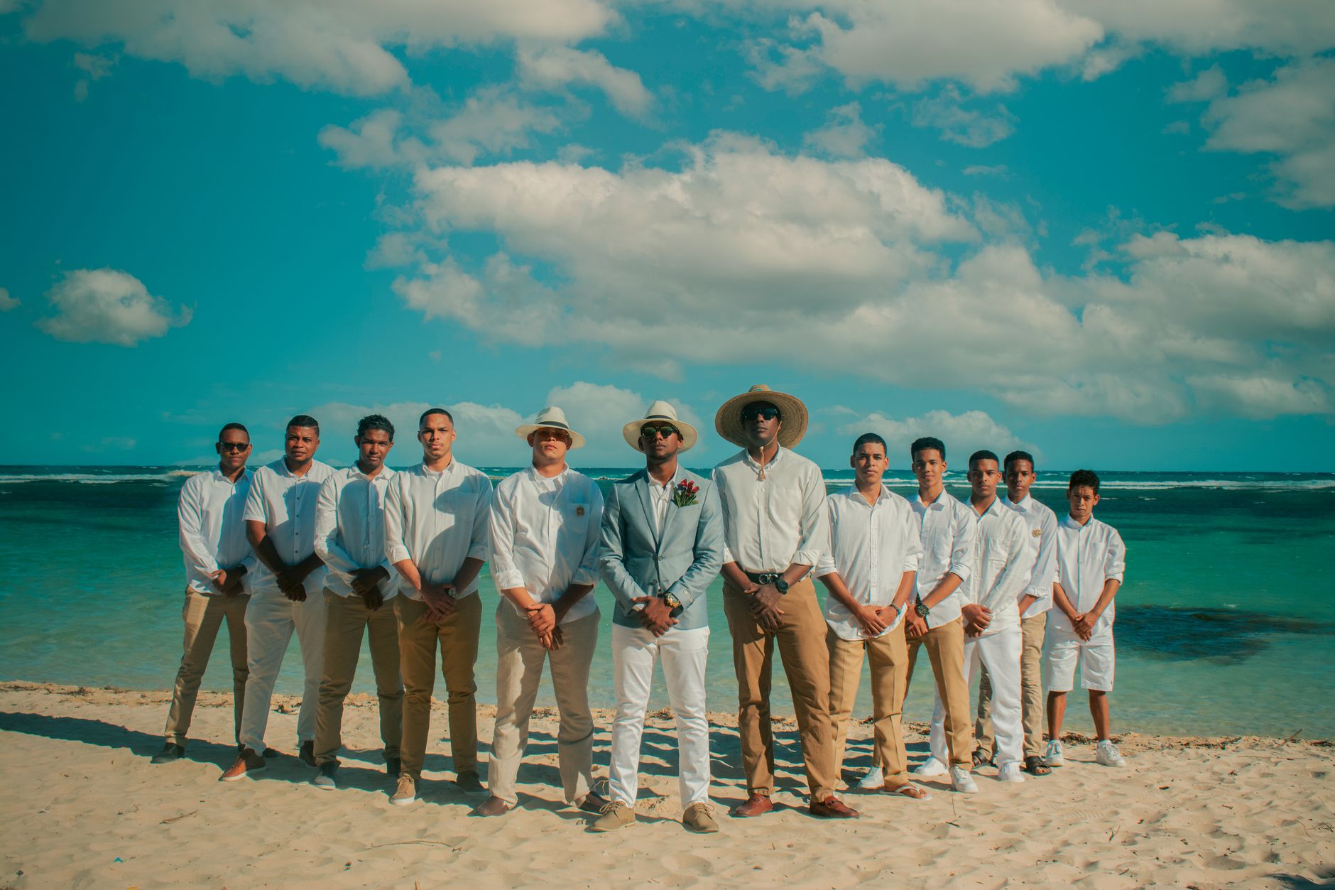 Beach wedding attire for men: light linen shirt and trousers by the water