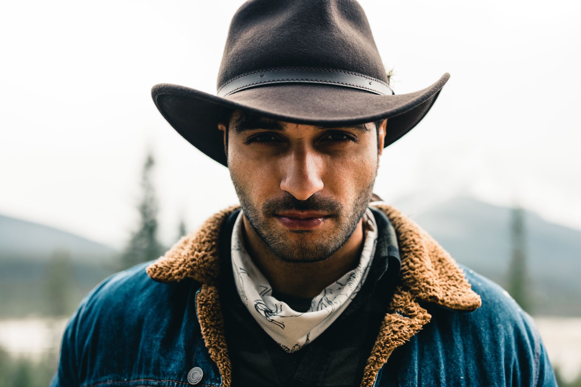Western costume party look with denim, plaid shirt, bandana and boots