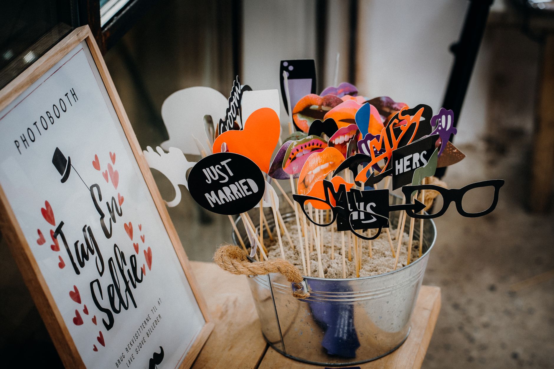 Photo booth corner with props, hats and masks at a themed party