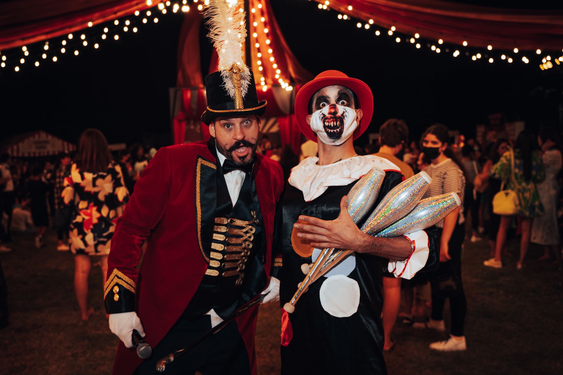 Ringmaster costume with red tailcoat, top hat and striped circus decor