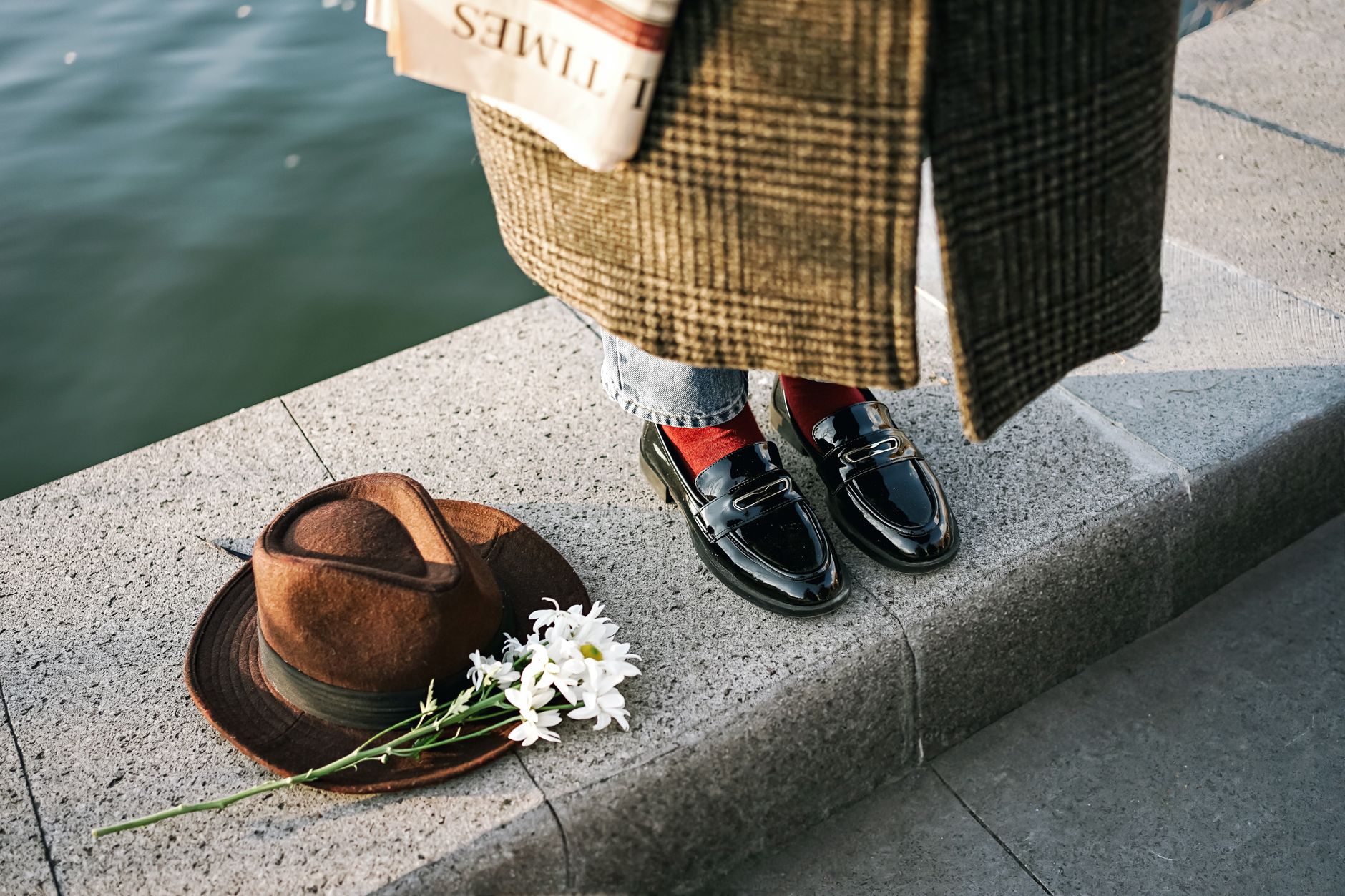 Leather derbies and loafers beside folded chinos