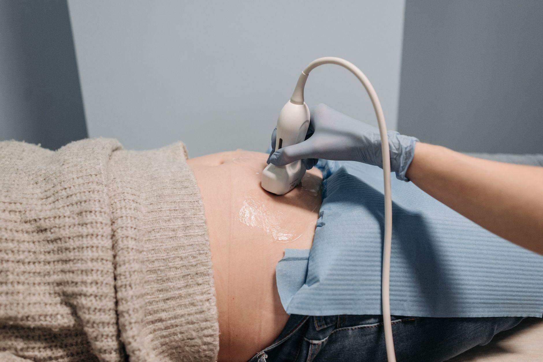 Ultrasound gel being applied to the abdomen before a cavitation session