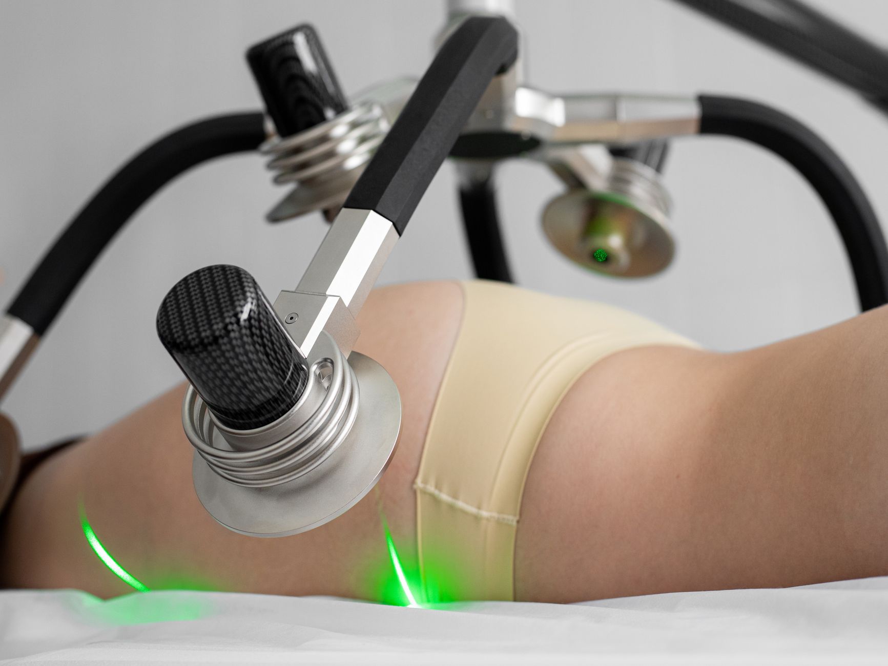 EMS body sculpting treatment on the abdomen in a clinic